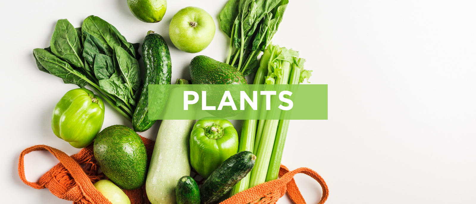 top view of different green fruits and vegetables scattered and a red cloth bag on top of a white table